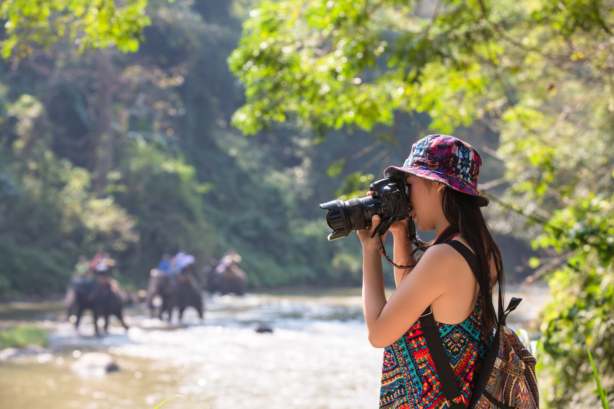 female tourists who are taking photos of the atmosphere and smile happily.